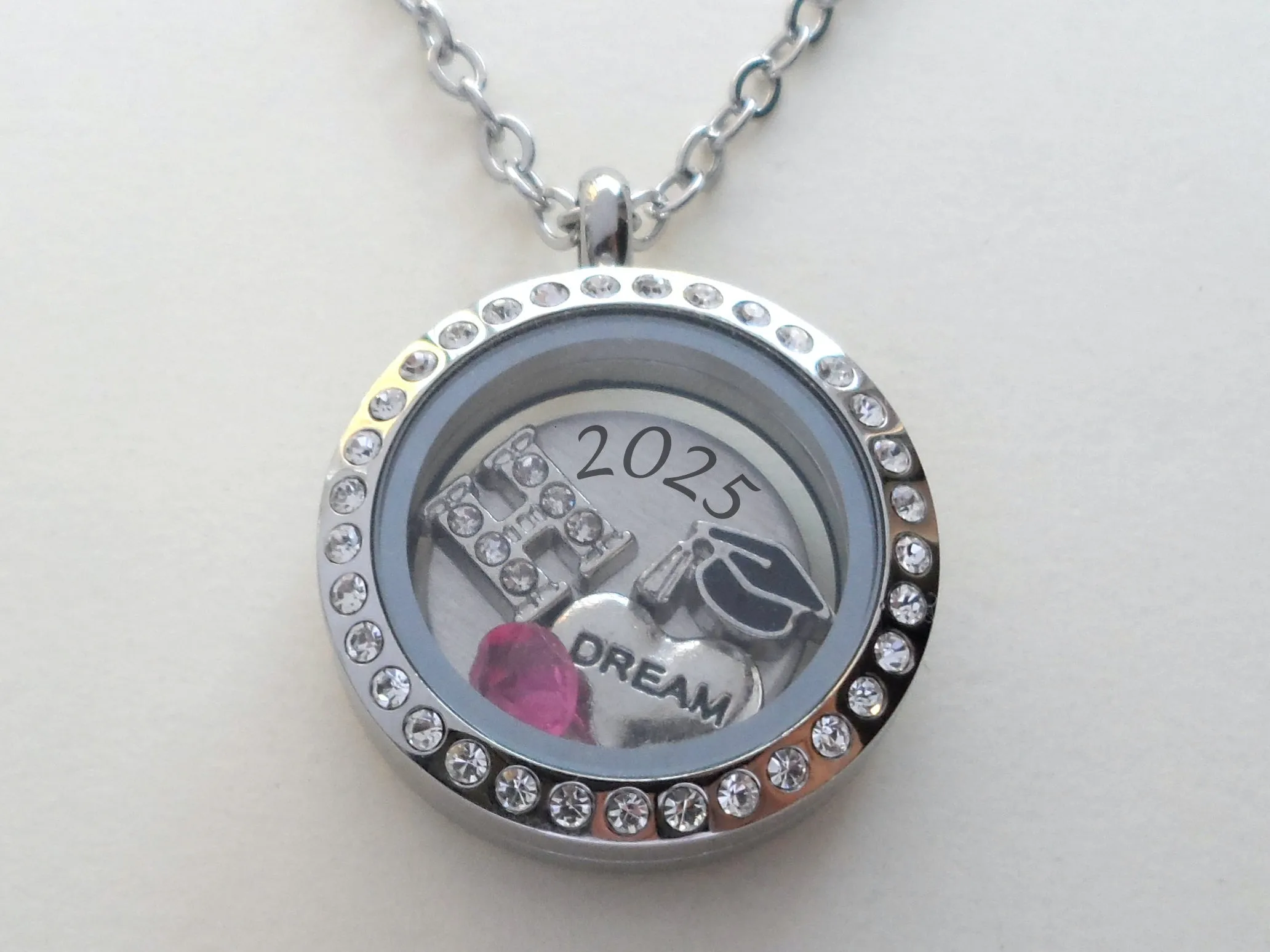 Class of 2025 Graduate Locket Necklace with Graduate Cap, 2025 Disc, and Custom Letter & Birthstone - by Jewelry Everyday